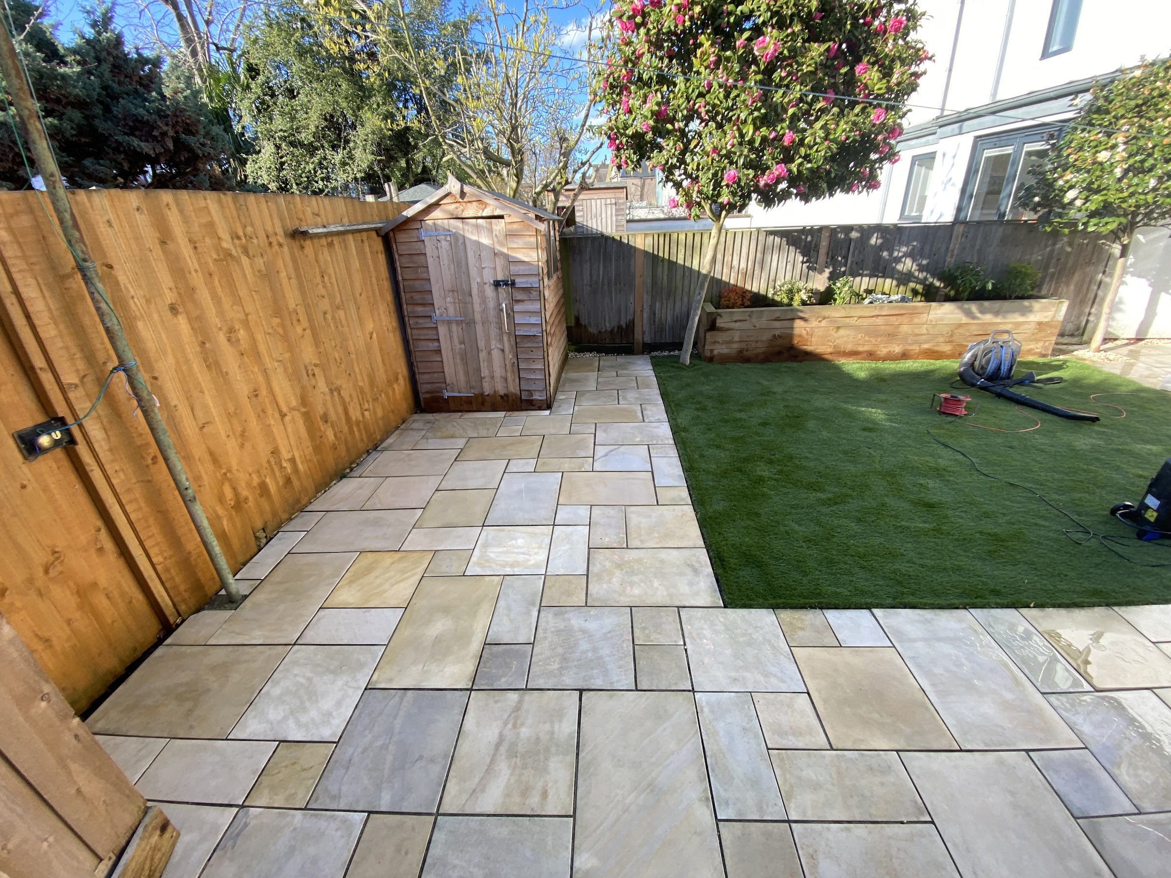A lush, healthy lawn framed by a well-kept garden in Surrey